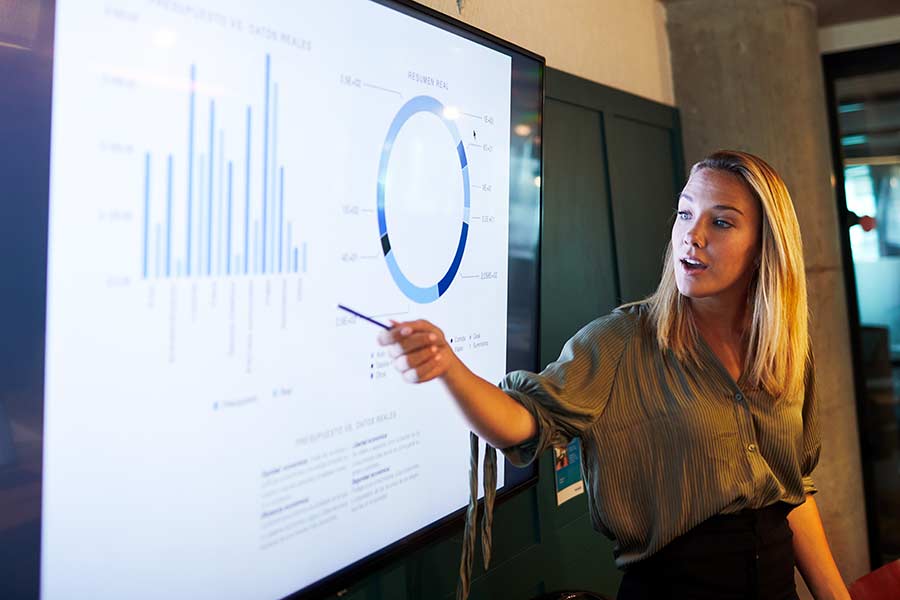 Woman giving a presentation in front of a screen