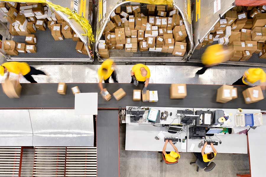 Conveyorbelt of boxes with people working